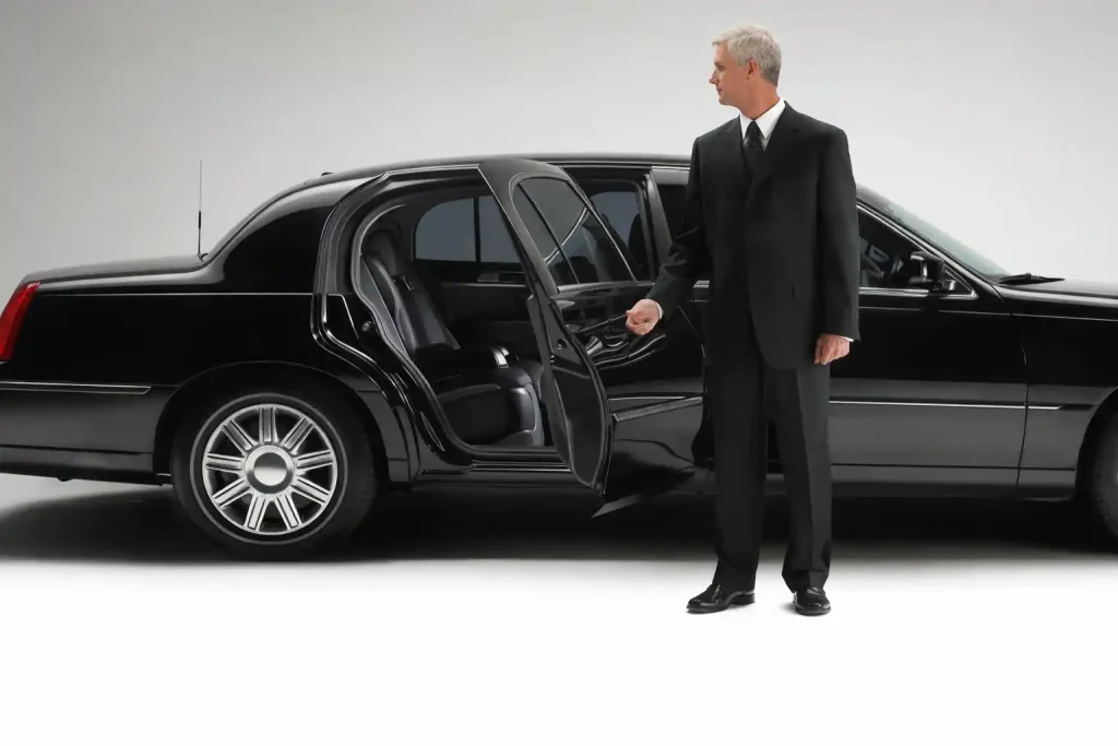 Professional driver waiting in black town car at Paine Field short-term parking