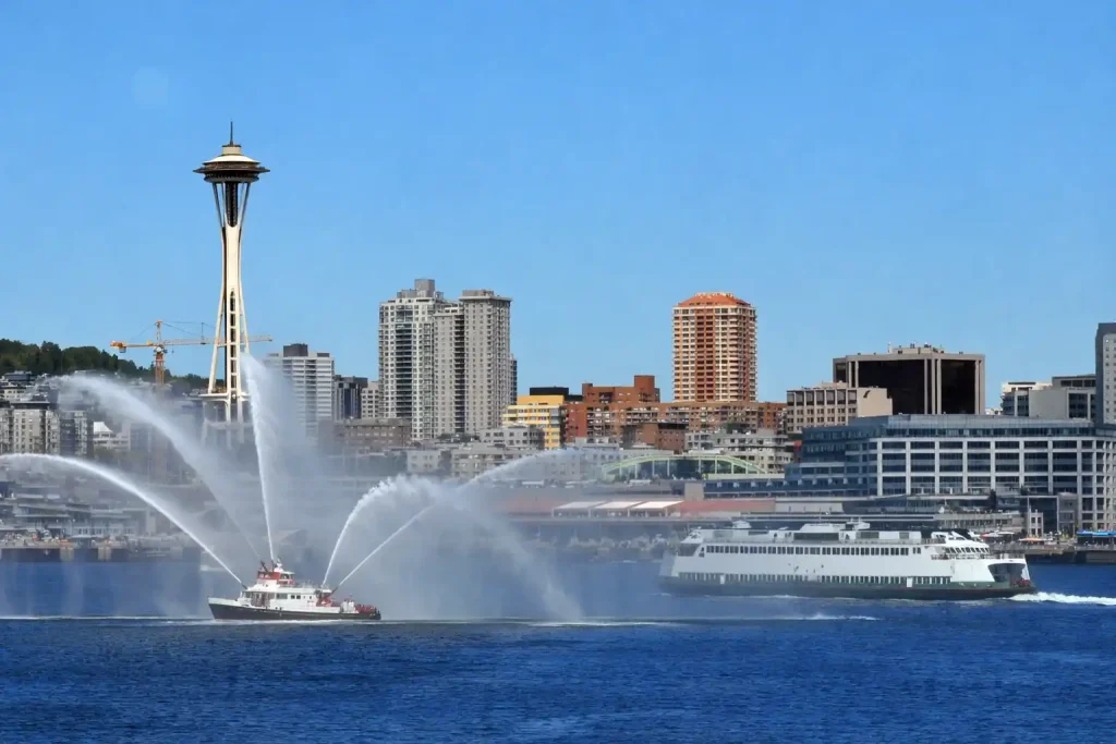 Seattle harbor cruise boat departing Pier 55 with downtown skyline and Space Needle view from Elliott Bay
