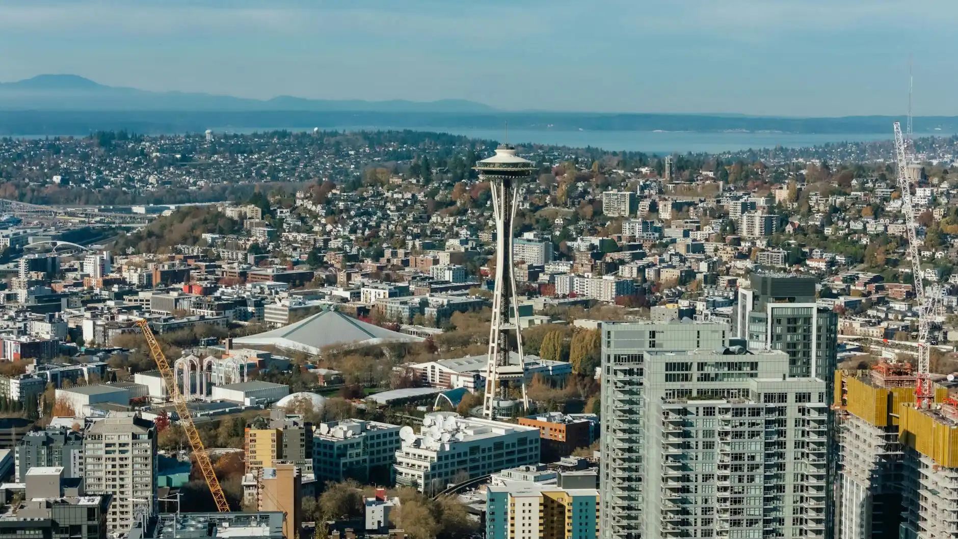 aerial map-style view of Interstate 5 from Seattle to Anacortes with highlighted route, coastal inlets, ferry terminal, and mountain backdrop