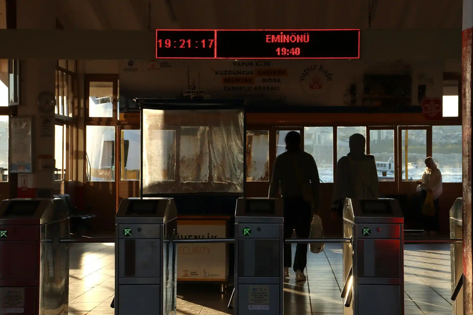 busy Anacortes ferry terminal loading lanes on a summer afternoon, numbered ferry lanes, families with luggage, terminal signs, cloudy coastal light