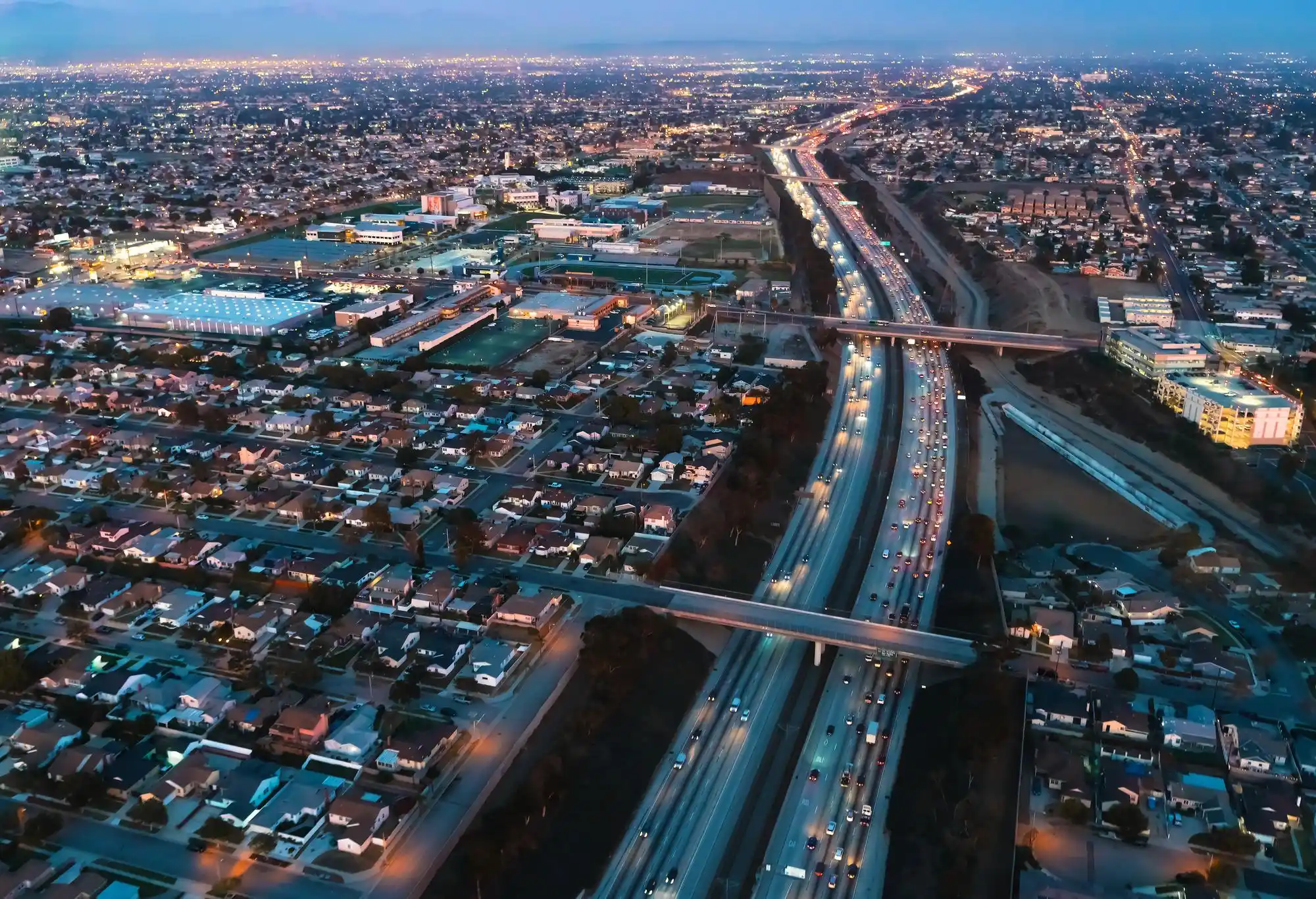 aerial view of Interstate 5 corridor from Anacortes toward Seattle with city skyline in distance, realistic traffic flow under overcast Pacific Northwest sky