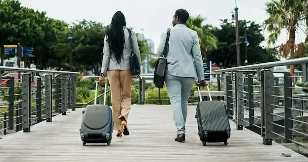 black luxury SUV dropping off cruise passengers with rolling luggage outside Seattle waterfront terminal on a clear summer morning, Space Needle faintly visible in background, p...