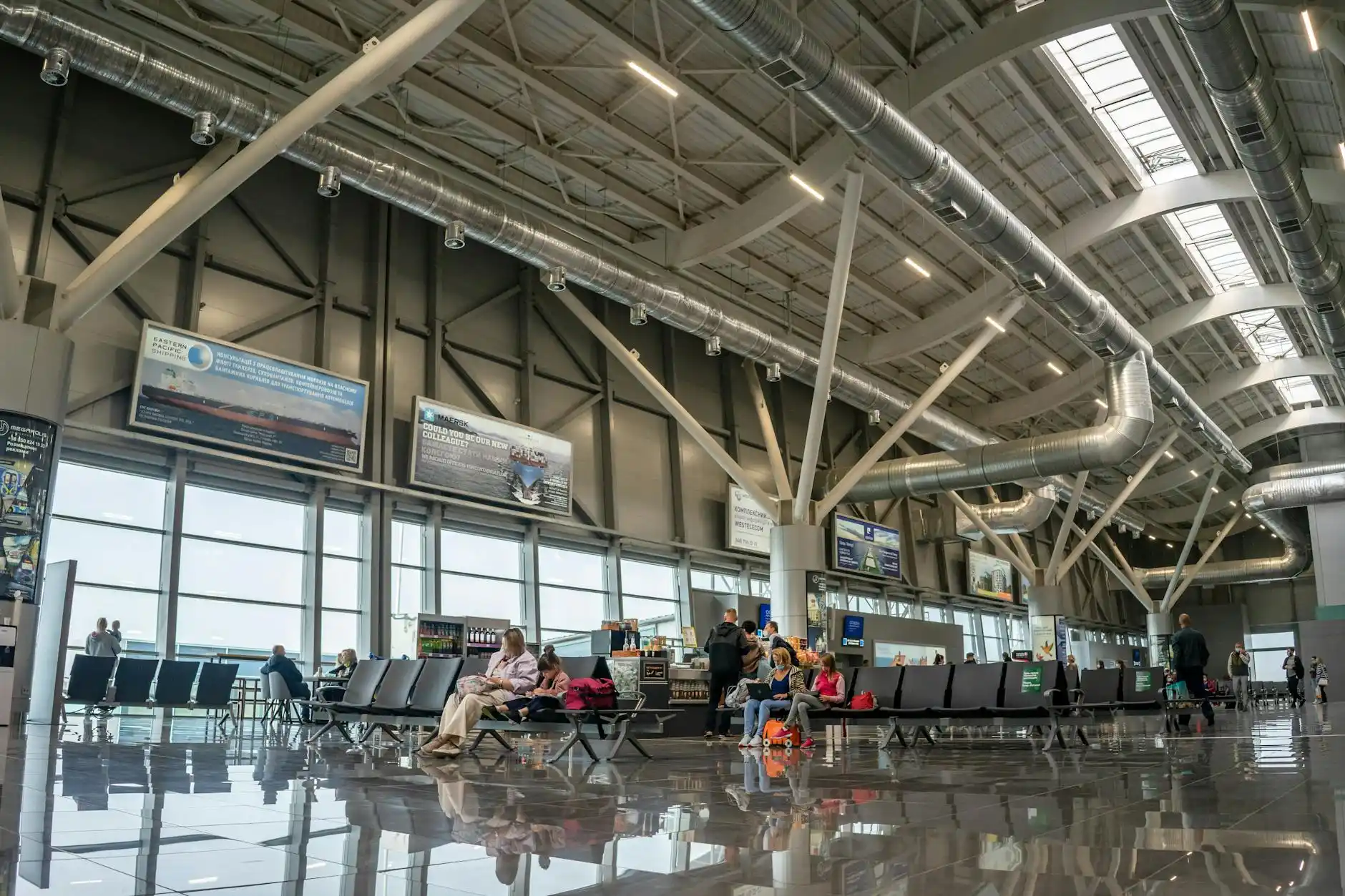 SeaTac terminal interior with concierge assisting a family with children and multiple suitcases near directional signs, realistic airport architecture and busy traveler flow