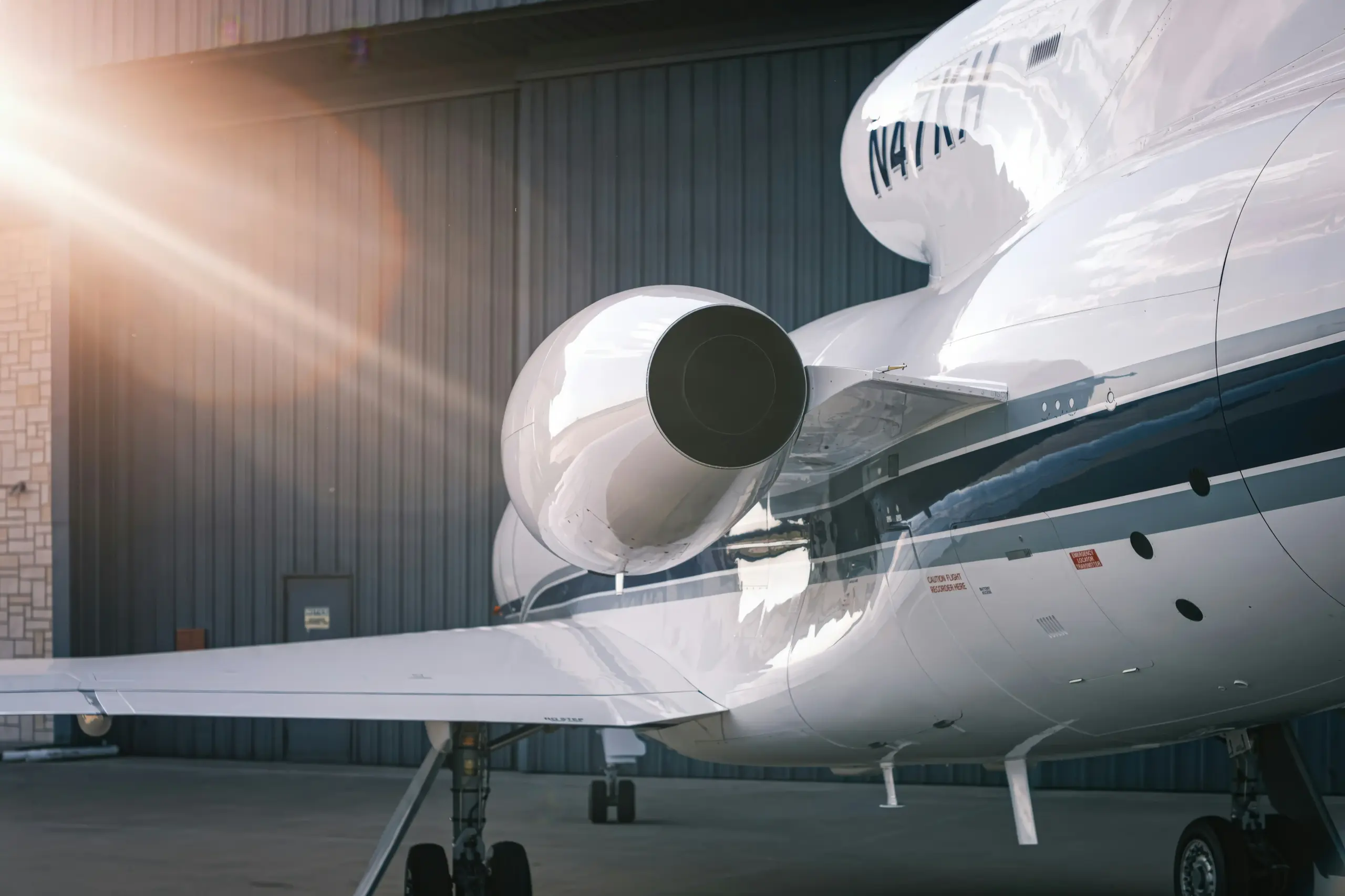 sleek black luxury SUV parked outside a private aviation terminal in Seattle at dusk, rain-slick pavement reflecting runway lights, chauffeur in dark suit holding tablet near ai...