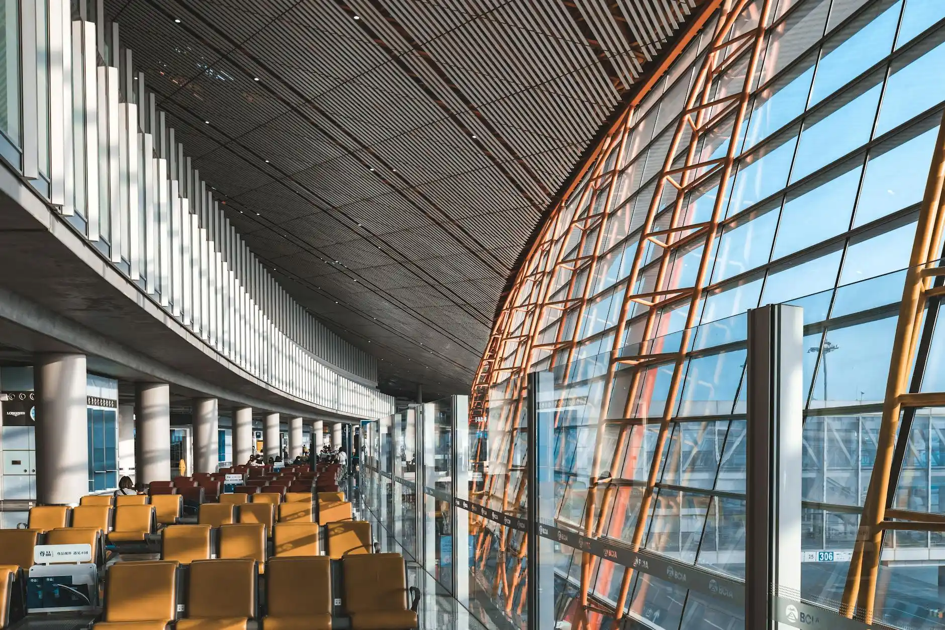 polished private terminal lounge in Seattle with leather seating, floor-to-ceiling windows overlooking parked jets, chauffeur in dark suit checking arrival updates on a phone