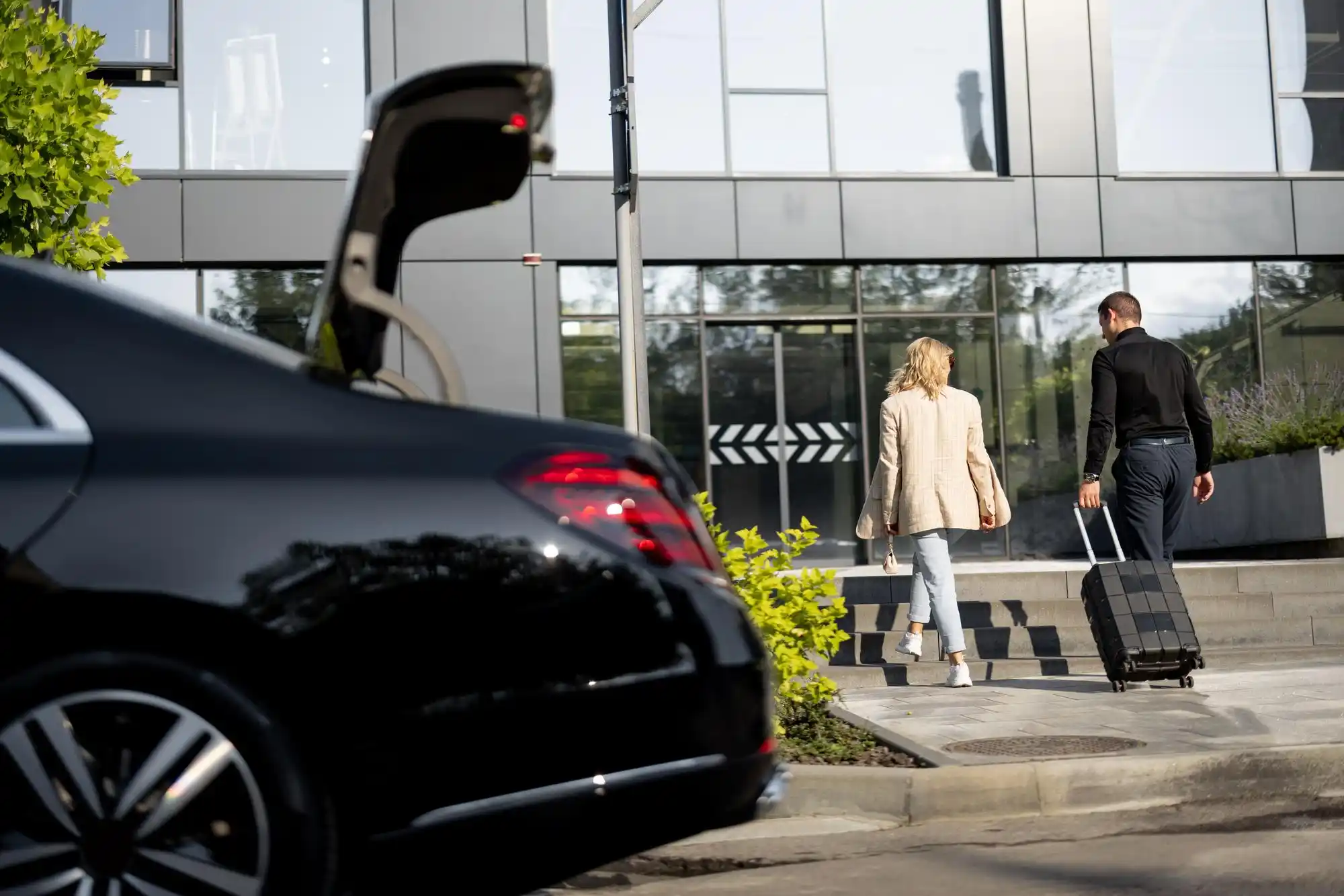 lineup of premium airport transfer vehicles in Seattle including black luxury sedan, executive SUV, and sprinter van with city skyline and Mount Rainier faintly visible in backg...
