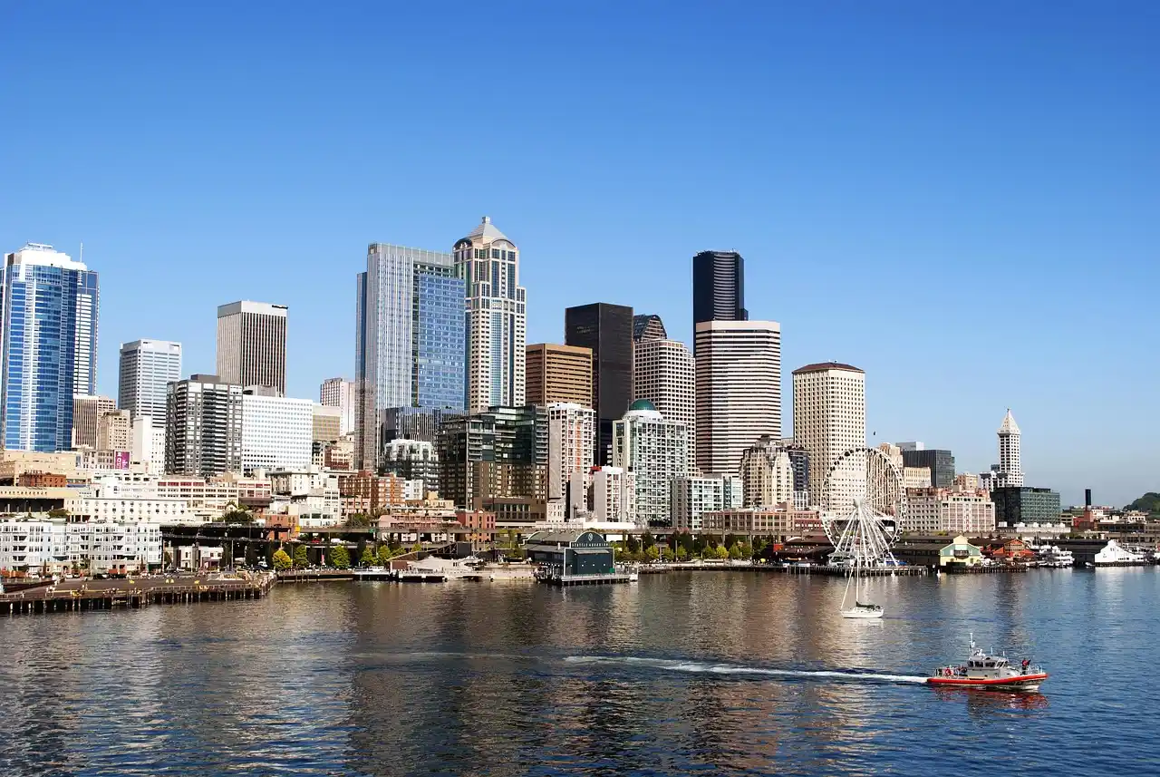 black luxury town car dropping off cruise passengers with rolling suitcases at Seattle waterfront on a bright morning, cruise ship visible in background, porter staff assisting ...