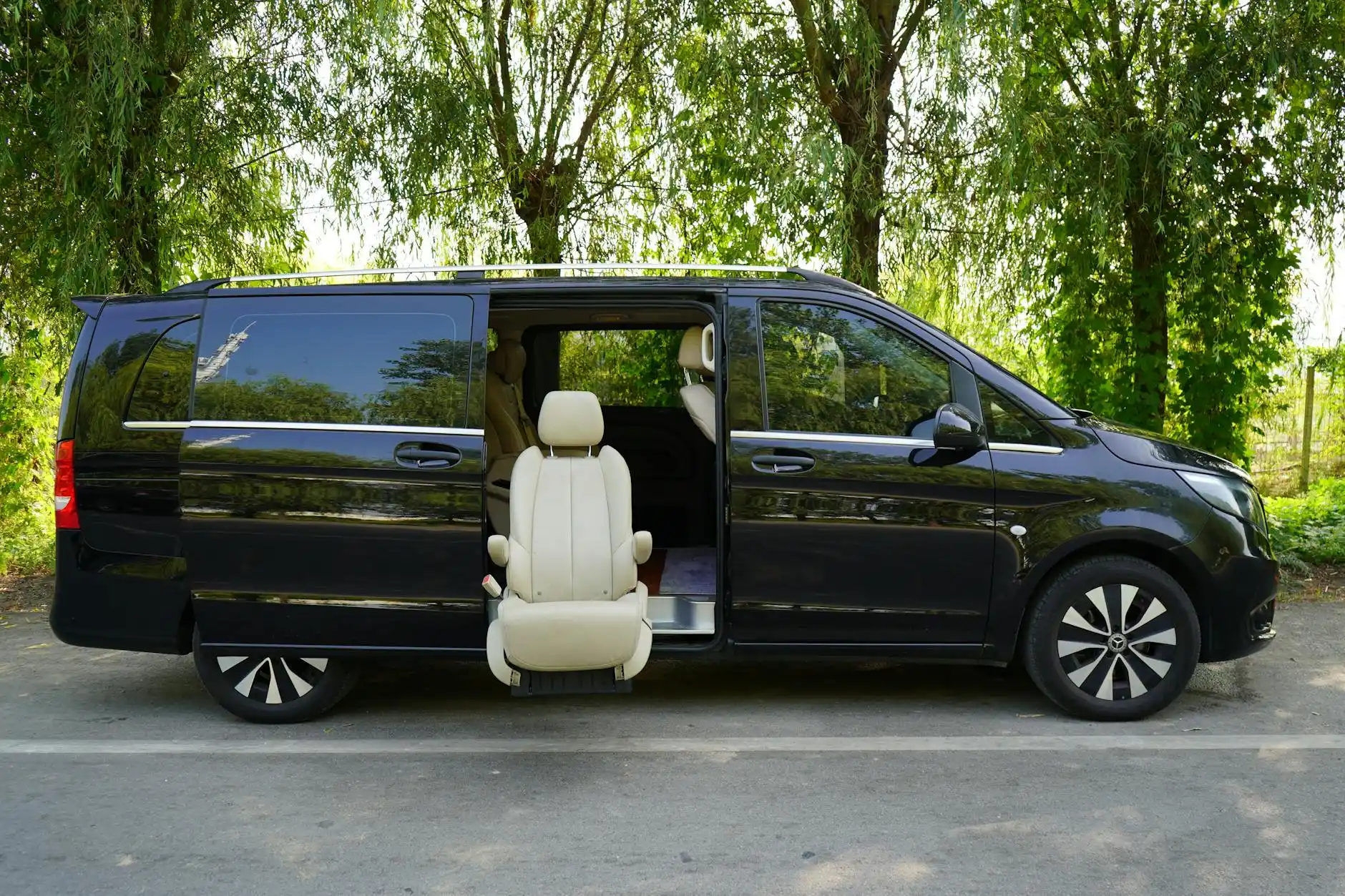 side-by-side visual comparison of a luxury sedan, black SUV, executive passenger van, and shared shuttle in front of Seattle skyline, clean commercial travel scene
