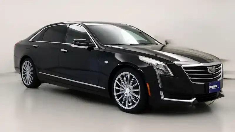 black luxury sedan pulling up to Seattle-Tacoma International Airport curbside on a rainy morning, sleek reflections on wet pavement, traveler with carry-on approaching driver i...