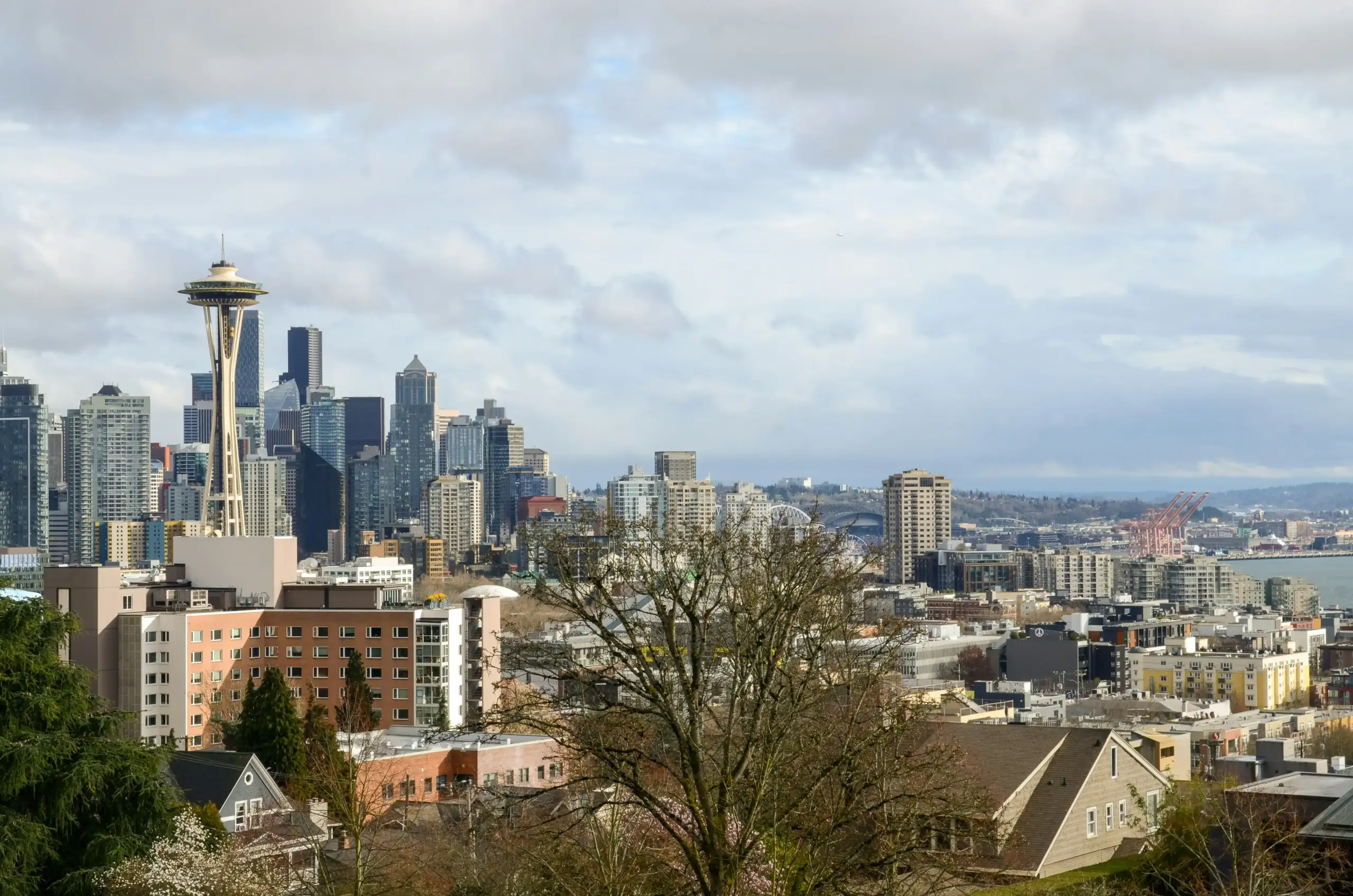 luxury SUV arriving at a downtown Seattle office tower, executives stepping out in formal business attire, glass skyscrapers and morning city traffic in the background