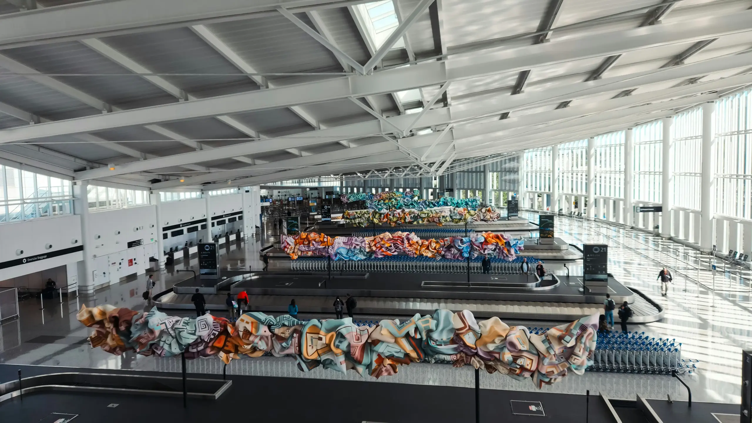 black luxury SUV curbside at Seattle-Tacoma International Airport arrivals on a rainy day, traveler loading luggage, airport signage visible, cinematic Pacific Northwest lighting