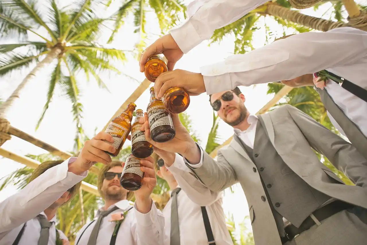 elegant white wedding party boarding a premium shuttle outside a Seattle waterfront venue at sunset, floral arrangements and formal attire visible