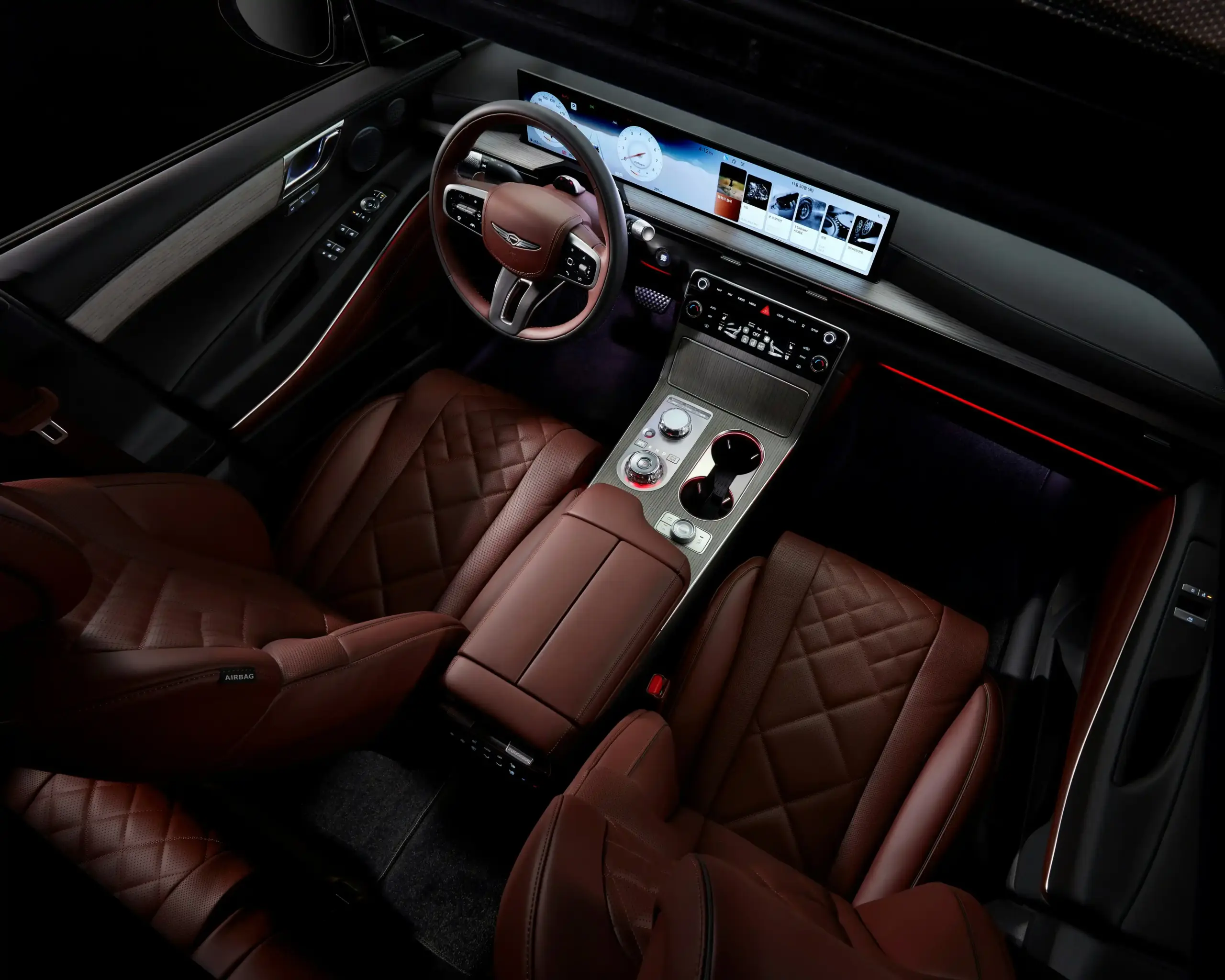 interior of a premium full-size SUV with tan leather seats, folded rear section, neatly arranged suitcases and carry-ons, rainy Seattle street outside