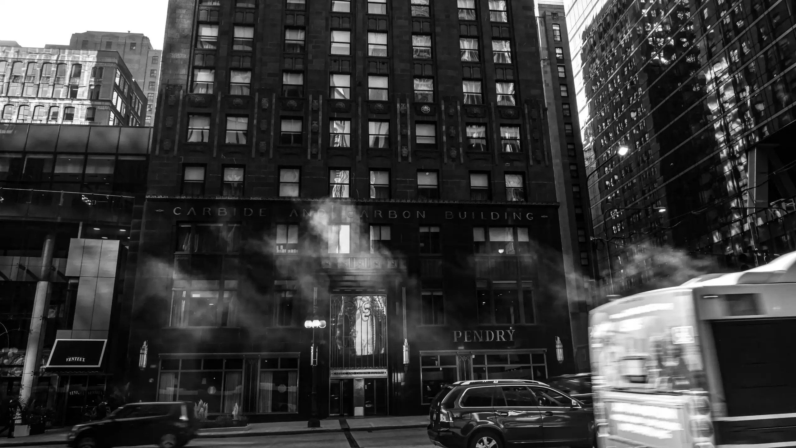 cruise passengers with rolling luggage outside a downtown Seattle hotel, black car and shuttle van at curbside, overcast morning, city streets and waterfront direction signs vis...