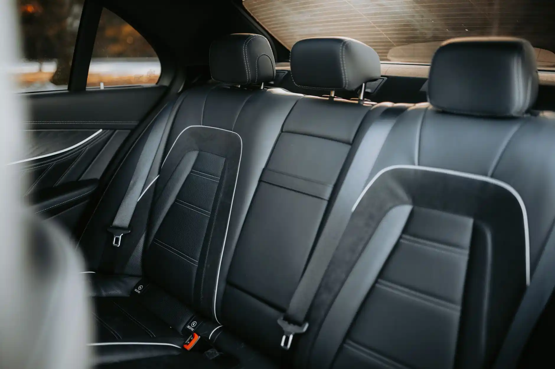 clean border-crossing travel scene with passports on a leather seat, smartphone map showing Seattle to Vancouver route, upscale SUV interior with large windows and carry-on luggage